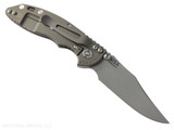Rick Hinderer Knives XM-18 Non Flipper 3.0" Bowie folding knife with thumb stud - shown open lock side.  Working Finish 20CV stainless steel plain edge blade.  OD Green G-10 handle with Battle Bronze lock side.  Model KXM30BOWNF.