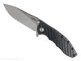 Zero Tolerance 0562CF folding knife with a flipper tab - open - logo side.  Satin 3.5" MagnaCut stainless steel plain edge blade.  Black carbon fiber handle with a gray titanium lock side.  Model 0562CF.