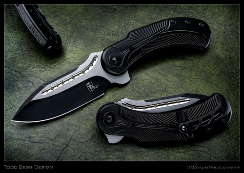 Todd Begg Knives Steelcraft Series Field Marshall folding knife - shown open presentation side.  2-tone satin S35VN stainless steel plain edge blade.  Black titanium handle.  Model FM212.
For reference only.