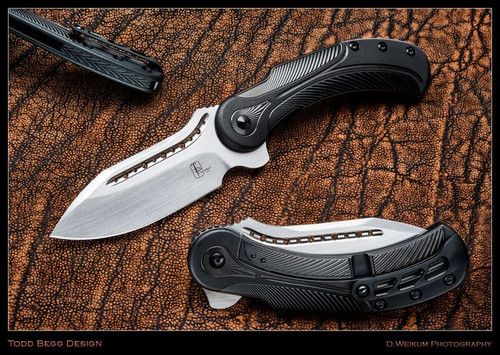Todd Begg Knives Steelcraft Series Field Marshall folding knife - shown open presentation side and closed pocket clip side.  Hand satin S35VN stainless steel plain edge blade.  Black titanium handle.  Model FM213.
For reference only.