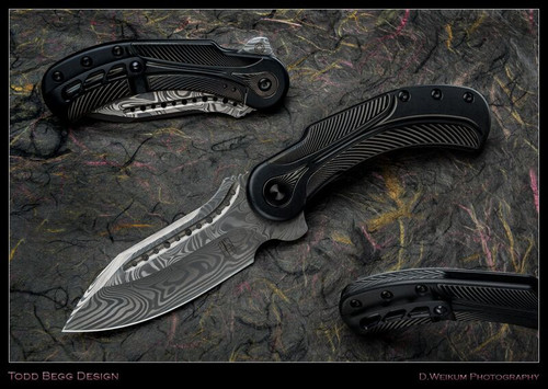 Todd Begg Knives Steelcraft Series Field Marshall folding knife - shown open presentation side, closed pocket clip side, and close up of back spacer.  Grosserosen Damascus steel plain edge blade.  Black titanium handle.  Model FM214.
For reference only.