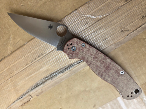 Used Spyderco Paramilitary 2 folding knife with thumb hole - shown open presentation side.  Cru-Wear steel plain edge blade.  Brown Micarta handle.  Model C81MPCW2.
