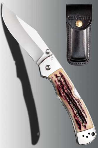 Cold Steel Mackinac Hunter folding knife  with thumb stud - shown open presentation side next to sheath.  AUS-8A stainless steel plain edge blade.  Delrin Faux Stag Horn handle.  Model 54FBTSL.
For reference only.