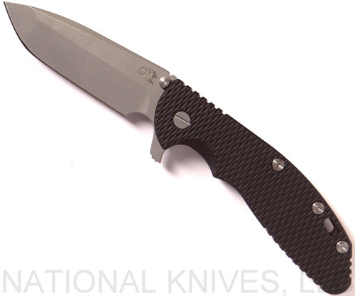 Rick Hinderer Knives XM-24 Spanto folding knife with thumb stud and flipper tab - shown open presentation side.  Working Finish 20CV stainless steel plain edge blade.  Black G-10 handle with Battle Bronze lock side.  Model K3003SGW00.