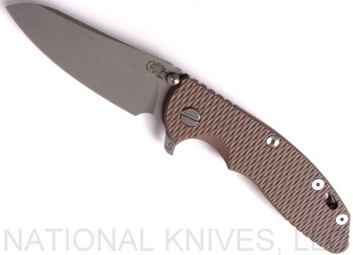 Rick Hinderer Knives Skinny XM-18 3.5" Sheepsfoot folding knife with thumb stud and flipper tab - shown open presentation side.  Working Finish 20CV stainless steel plain edge blade.  FDE G-10 handle with Working Finish lock side.  Model K2525SGS00.