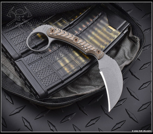 RMJ Tactical Korbin Karambit fixed blade knife - shown out of sheath reverse.  Tungsten Cerakote Nitro-V stainless steel plain edge blade.  Hyena Brown G-10 handle.  Model K-KO-TU-HB.
