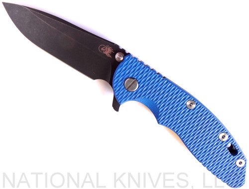 Rick Hinderer Knives XM-18 3.5" Spear Point folding knife with thumb stud and flipper tab - shown open presentation side.  Battle Black 20CV stainless steel plain edge blade.  Blue G-10 handle with Battle Black lock side.  Model K2082SGDSW.