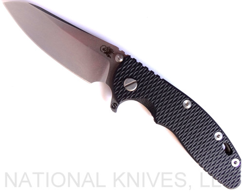Rick Hinderer Knives Skinny XM-18 3.5" Sheepsfoot folding knife with thumb stud and flipper tab - shown open presentation side.  Stonewash 20CV stainless steel plain edge blade.  Black G-10 handle with stonewash bronze lock side.  Model K2525SGS00.
