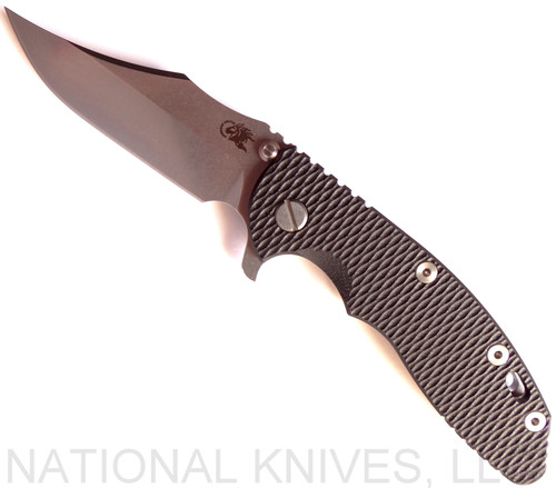 Rick Hinderer Knives XM-18 3.5" Bowie folding knife with thumb stud and flipper tab - shown open presentation side.  Stonewash 20CV stainless steel plain edge blade.  Black G-10 handle with stonewash titanium lock side.  Model K2032SGS00.