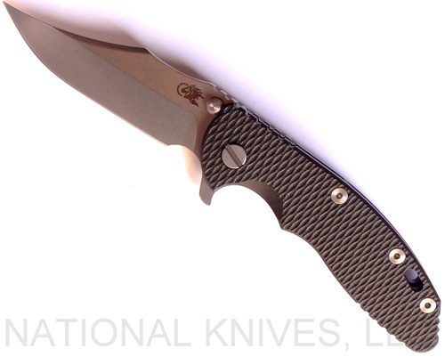 Rick Hinderer Knives XM-18 3.5" Bowie folding knife with thumb stud and flipper tab - shown open presentation side.  Stonewash 20CV stainless steel plain edge blade.  Black G-10 handle with stonewash blue titanium lock side.  Model K2032SGS00.
