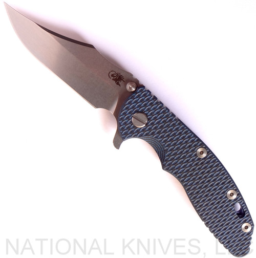 Rick Hinderer Knives XM-18 3.5" Bowie folding knife with thumb stud and flipper tab - shown open presentation side.  Stonewash 20CV stainless steel plain edge blade.  Blue - black G-10 handle with stonewash blue titanium lock side.  Model K2032SGS00.
