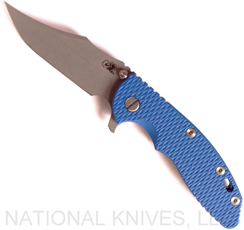 Rick Hinderer Knives XM-18 3.5" Bowie folding knife with thumb stud and flipper tab - shown open presentation side.  Working Finish 20CV stainless steel plain edge blade.  Blue G-10 handle with Battle Blue titanium lock side.  Model K2032SGW00.