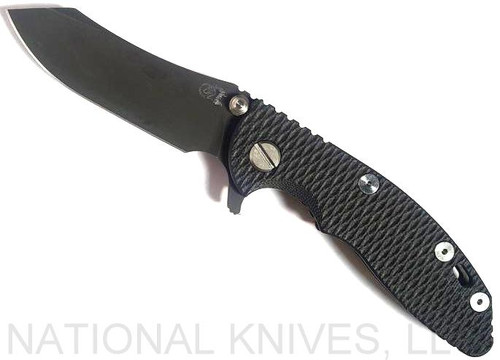 Rick Hinderer Knives XM-18 3.0" Skinner folding knife with thumb studs and flipper tab - shown open presentation side.  Battle Black 20CV stainless steel plain edge blade.  Black G-10 handle with Battle Black lock side.  Model K1041SGD00.
