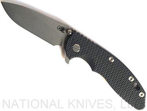 Rick Hinderer Knives XM-18 3.5" Slicer folding knife with thumb stud and flipper tab - shown open presentation side.  Working Finish 20CV stainless steel plain edge blade.  Black G-10 handle with Working Finish lock side.  Model K310102001.
