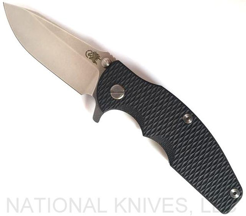 Rick Hinderer Knives Jurassic Spear Point folding knife with thumb stud and flipper tab - shown open presentation side.  Stonewash 20CV stainless steel plain edge blade.  Black G-10 handle with stonewash lock side.  Model K208JSGS00.
