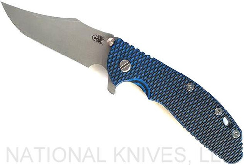 Rick Hinderer Knives XM-24 Bowie folding knife with thumb stud and flipper tab - shown open presentation side.  Working Finish 20CV stainless steel plain edge blade.  Blue - black G-10 handle with Working Finish lock side.  Model KXM40BO.