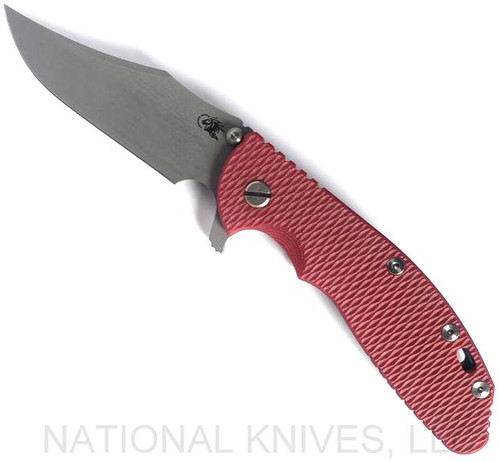 Rick Hinderer Knives XM-24 Bowie folding knife with thumb stud and flipper tab - shown open presentation side.  Working Finish 20CV stainless steel plain edge blade.  Red G-10 handle with Battle Blue lock side.  Model KXM40BO.