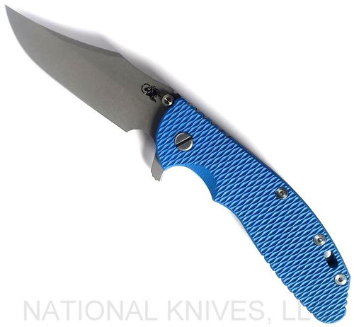 Rick Hinderer Knives XM-24 Bowie folding knife with thumb stud and flipper tab - shown open presentation side.  Working Finish 20CV stainless steel plain edge blade.  Blue G-10 handle with Battle Blue lock side.  Model KXM40BO.