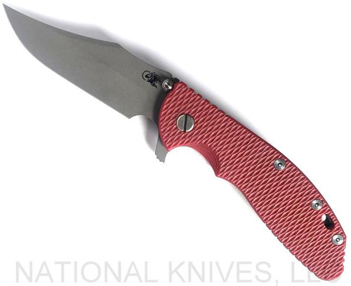 Rick Hinderer Knives XM-24 Bowie folding knife with thumb stud and flipper tab - shown open presentation side.  Working Finish 20CV stainless steel plain edge blade.  Red G-10 handle with Battle Bronze lock side.  Model KXM40BO.