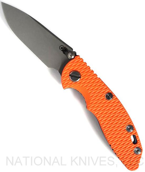 Rick Hinderer Knives Non=Flipper XM-18 3.0" Slicer folding knife with thumb stud - shown open presentation side.  Working Finish 20CV stainless steel plain edge blade.  Orange G-10 handle with Battle Blue lock side.  Model KXM30SLNF.