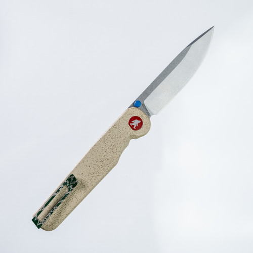 Tactile Knife Co Seasonal Release Trailhead Rockwall folding knife with a thumb stud - shown open pocket clip side.  Stonewashed MagnaCut stainless steel plain edge blade.  Beige coated titanium handle.  Model 20-RT-MCTH-TTTH.