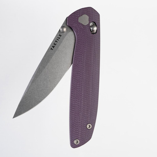 Tactile Knife Co Maverick folding knife with a thumb stud.  Shown partially open presentation side.  Stonewashed MagnaCut stainless steel plain edge blade.  Purple G-10 handle.  Model 20-MV-MC01-GXPU.