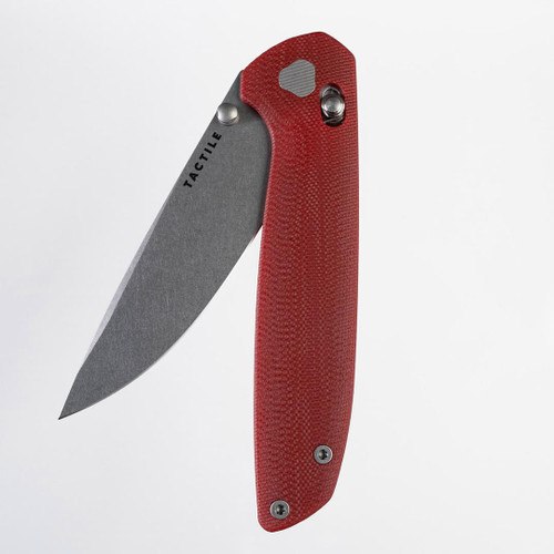 Tactile Knife Co Maverick folding knife with a thumb stud.  Shown partially open presentation side.  Stonewashed MagnaCut stainless steel plain edge blade.  Red G-10 handle.  Model 20-MV-MC01-GXRD.