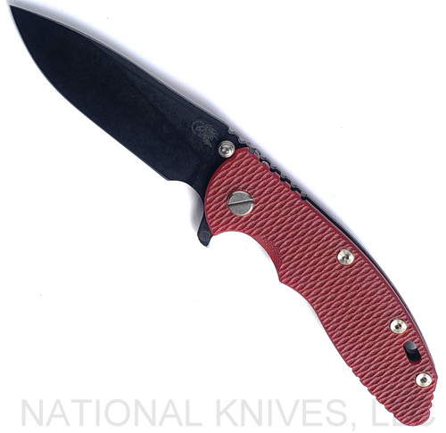 Rick Hinderer Knives Skinny XM-18 3.5" Slicer folding knife with thumb stud and flipper tab - shown open presentation side.  Battle Black MagnaCut stainless steel plain edge blade.  Red G-10 handle with Battle Black lock side.  Model KXM35SKSLDLC.