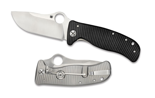 Spyderco Lionspy folding knife with thumb hole - shown open presentation side and closed pocket clip side.  Satin Elmax stainless steel plain edge blade. Black G-10 handle with titanium lock side.  Model C157GTIP.
For reference only.

