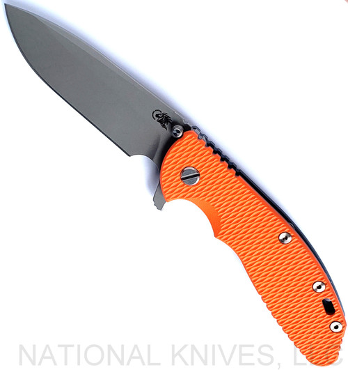 Rick Hinderer Knives XM-24 Spear Point folding knife with thumb stud and flipper tab - shown open presentation side.  Working Finish S45VN stainless steel plain edge blade.  Orange G-10 handle with Battle Blue lock side.  Model KXM40SPE.