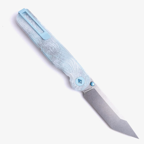 Tactile Knife Co Seasonal Release Icefall Rockwall folding knife with a thumb stud - shown open pocket clip side.  Stonewashed MagnaCut stainless steel plain edge Tanto blade.  Multi colored coated titanium handle.  Model 20-RT-MCTN-ICE.
For reference only.