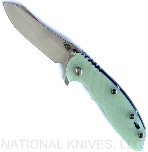 Rick Hinderer Knives XM-18 3.5" Skinner folding knife with thumb stud and flipper tab - shown open presentation side.  Stonewash S45VN stainless steel plain edge blade.  Translucent Green G-10 handle with stonewash blue lock side.  Model KXM35SKINNER.
