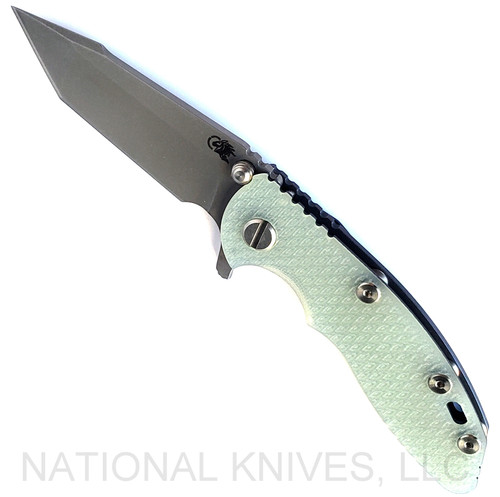 Rick Hinderer Knives XM-18 3.0" Harpoon Tanto folding knife with thumb stud and flipper tab - shown open presentation side.  Working Finish S45VN stainless steel plain edge blade.  Translucent Green G-10 handle with Battle Blue lock side.  Model KXM3000HT.