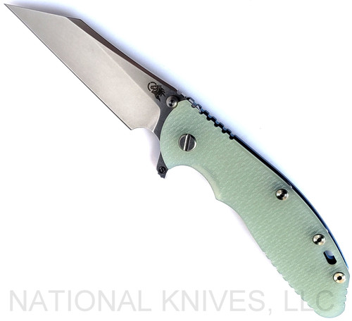 Rick Hinderer Knives Skinny XM-24 Wharncliffe folding knife with thumb stud and flipper tab - shown open presentation side.  Stonewash S45VN stainless steel plain edge blade.  Translucent Green G-10 handle with stonewash blue lock side.  Model KXM40SKWC.