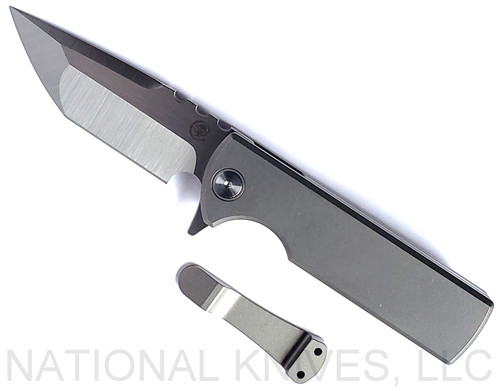 Chaves Knives Integral T.A.K. folding knife featuring a flipper tab - shown open presentation side.  Satin M390 stainless steel tanto style plain edge blade.  Stonewash titanium handle.  Model CK-1C1-2A1B-1A0.