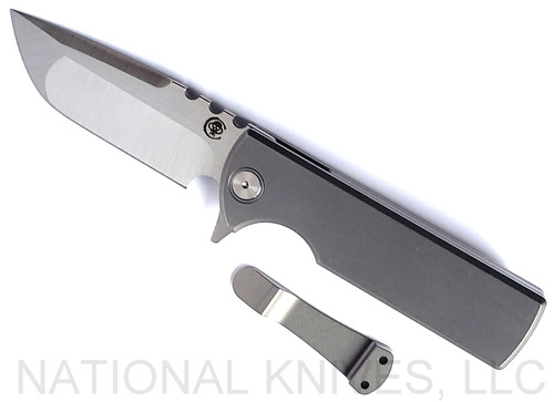 Chaves Knives Integral T.A.K. folding knife featuring a flipper tab - shown open presentation side.  Satin M390 stainless steel drop point style plain edge blade.  Stonewash titanium handle.  Model CK-1C1-1A1B-1A0.