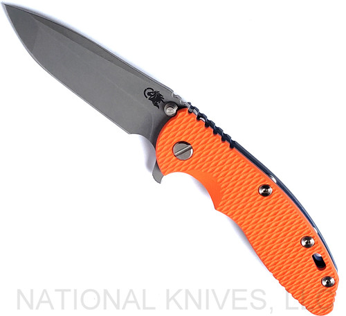 Rick Hinderer Knives XM-18 3.5" Spanto folding knife with thumb stud and flipper tab - shown open presentation side.  Working Finish S45VN stainless steel plain edge blade.  Orange G-10 handle with Battle Blue lock side.  Model KXM35SPA.