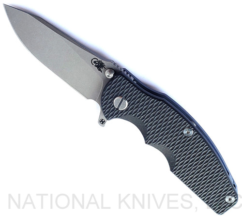 Rick Hinderer Knives Jurassic Hollow Grind Slicer folding knife with flipper tab - shown open presentation side.  Working Finish MagnaCut stainless steel plain edge blade.  Black G-10 handle scale with Battle Blue titanium lock side.  Model KJURSLHO.