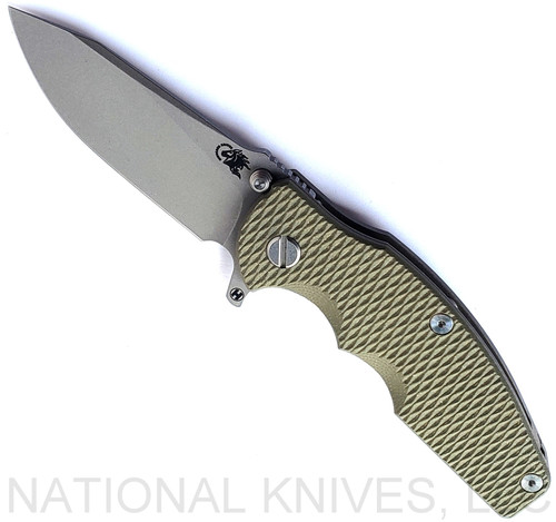 Rick Hinderer Knives Jurassic Hollow Grind Slicer folding knife with flipper tab - shown open presentation side.  Working Finish MagnaCut stainless steel plain edge blade.  OD Green G-10 handle scale with Battle Bronze titanium lock side.  Model KJURSLHO.