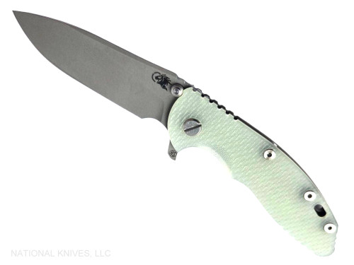 Rick Hinderer Knives XM-18 Skinny Slicer with thumb stud and flipper tab - shown open presentation side.  Working Finish Magnacut stainless steel, hollow ground, plain edge blade.  Translucent Green G-10 handle with Battle Bronze lock side. 