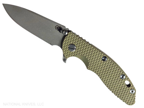 Rick Hinderer Knives XM-18 Skinny Slicer with thumb stud and flipper tab - shown open presentation side.  Working Finish Magnacut stainless steel, hollow ground, plain edge blade.  OD green G-10 handle with Battle Green lock side. 