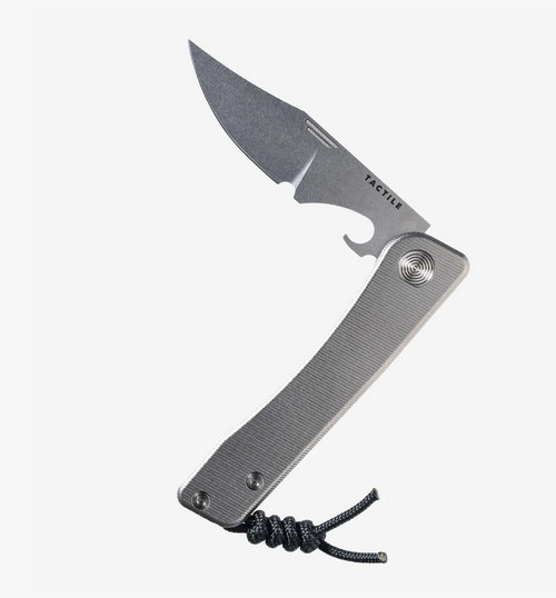 Tactile Knife Co Bexar slip joint pocket knife with bottle opener and thumbnail slot - shown partially open obverse.  Stonewash MagnaCut stainless steel plain edge blade.  Titanium handle.  Model 20-BXB-MC01-TT01.