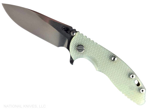 Rick Hinderer Knives XM-18 Skinny Slicer with thumb stud and flipper tab - shown open presentation side.  Stonewash Magnacut stainless steel, hollow ground, plain edge blade.  Translucent Green G-10 handle with stonewash bronze lock side. 