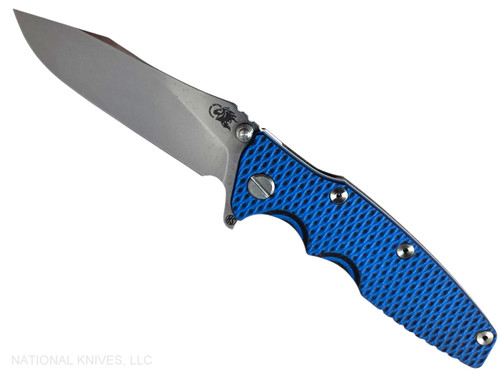 Rick Hinderer Knives Skinny Eklipse Slicer folding knife with flipper tab - shown open - presentation side.  Stonewash 3.5" hollow grind MagnaCut stainless steel plain edge blade.  Blue - black G-10 handle scale with stonewashed bronze lock side.  Model KEK35SKSLHO