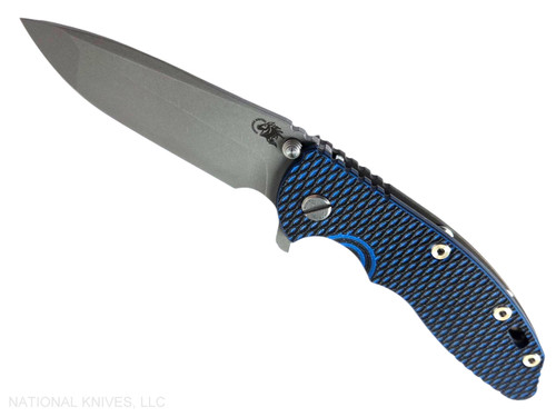 Rick Hinderer Knives XM-18 3.5" Spanto folding knife with thumb stud and flipper tab - shown open presentation side.  Working Finish 20CV stainless steel plain edge blade.  Blue - black G-10 handle with Battle Bronze lock side.  Model KXM35SPA.