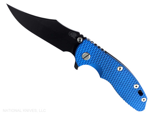 Rick Hinderer Knives XM-18 3.5" Bowie folding knife with thumb stud and flipper tab - shown open presentation side.  Battle Black MagnaCut stainless steel plain edge blade.  Blue G-10 handle with Battle Black lock side.  Model KXM35BOWMC.