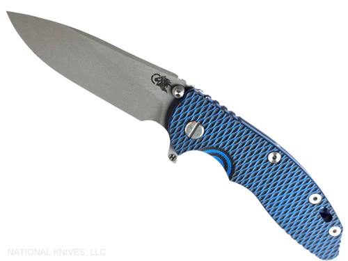 Rick Hinderer Knives XM-18 3.5" Slicer Hollow Grind folding knife with thumb stud and flipper tab - shown open presentation side.  Working Finish 20CV stainless steel plain edge blade.  Blue - black G-10 handle with Battle Blue lock side.  Model KXM35SLHO.