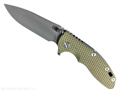 Rick Hinderer Knives XM-18 3.5" Slicer Hollow Grind folding knife with thumb stud and flipper tab - shown open presentation side.  Working Finish 20CV stainless steel plain edge blade.  OD green G-10 handle with Battle Blue lock side.  Model KXM35SLHO.