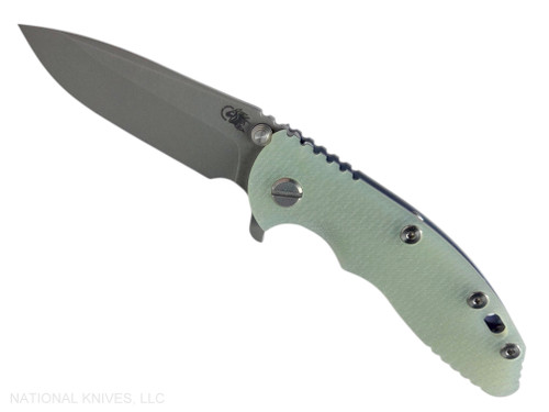 Rick Hinderer Knives XM-18 3.25" Spear Point folding knife with thumb stud and flipper tab - shown open presentation side.  Working Finish S45VN stainless steel plain edge blade.  Translucent Green G-10 handle with Battle Blue lock side.  Model KXM325SPE.