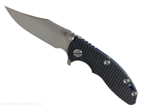 Rick Hinderer Knives XM-18 3.0" Bowie folding knife with thumb stud and flipper tab - shown open presentation side.  Stonewash 20CV stainless steel plain edge blade.  Black G-10 handle with stonewashed blue lock side.  Model KXM30BOW.